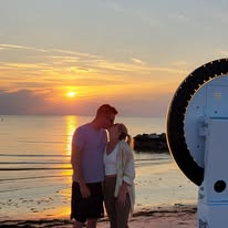 Couple with the Shore Shots photobooth at the beach